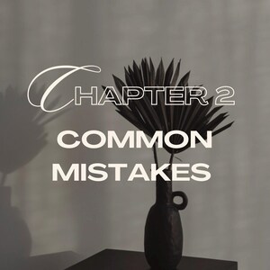 May include: A black vase with a dark palm frond arrangement sits on a black table. The text "CHAPTER 2 COMMON MISTAKES" is overlaid in white, with a stylized font for "CHAPTER 2". The background is a neutral gray.
