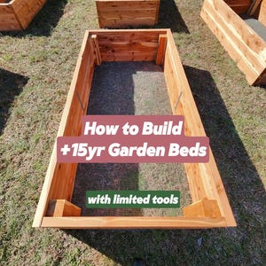 May include: Three raised garden beds made of cedar wood. The beds are filled with soil and have a wire mesh lining. The text "How to Build +15yr Garden Beds with limited tools" is superimposed on the image.