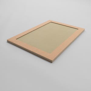 May include: A rectangular, light brown picture frame with a light tan interior. The frame is made of wood and has a simple, modern design. The frame is empty and ready to display a photo or artwork.