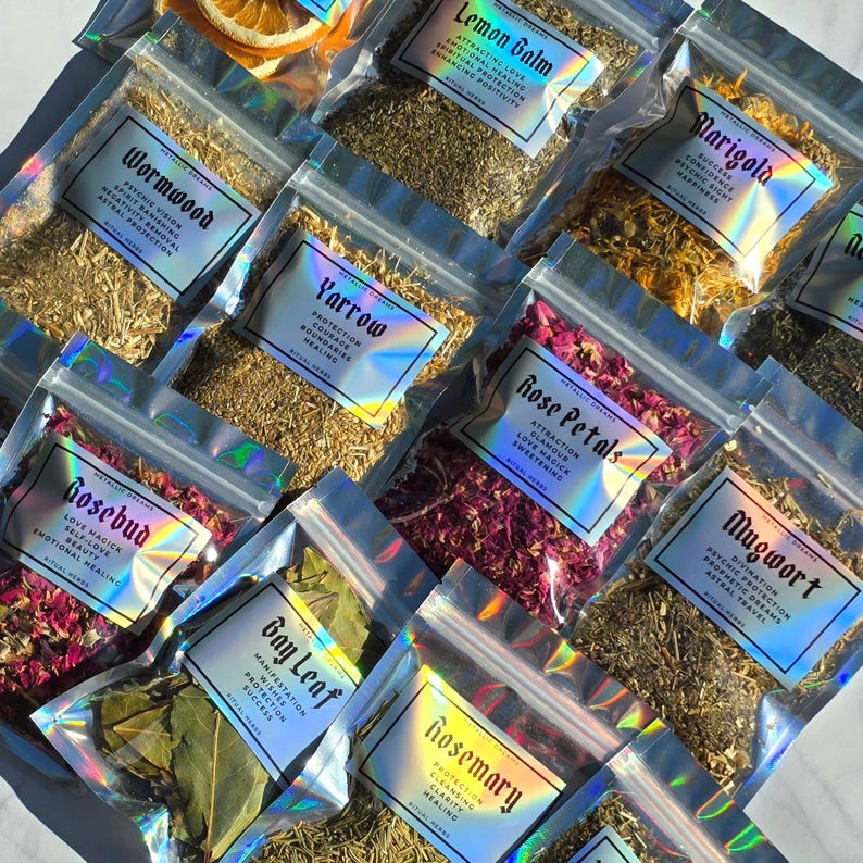 May include: An assortment of dried herbs and botanicals in clear, resealable bags. Each bag features a label with a holographic effect, detailing the herb's name and properties. Herbs include Lemon Balm, Yarrow, and Bay Leaf. The image has a bright, natural light.