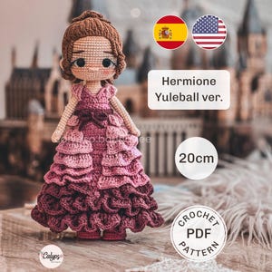 May include: A crochet doll featuring brown hair and a layered, ruffled dress in shades of pink and burgundy. The text on the image reads 'Hermione Yuleball ver.', '20cm', and 'CROCHET PDF PATTERN'. The doll has large dark eyes and a small nose.