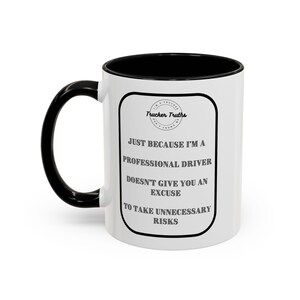 May include: White ceramic coffee mug with a black handle and black rim. The mug has a black and white graphic that reads "Trucker Truths" and "Just because I'm a professional driver doesn't give you an excuse to take unnecessary risks."