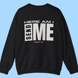 May include: Black sweatshirt with white text that reads "HERE AM I SEND ME" and "ISAIAH 6:8".