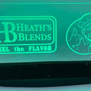 May include: Green illuminated sign with the text "Heath's Blends" and "Feel the Flavor" with a cartoon chef giving a thumbs up.