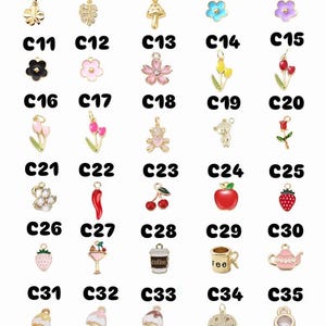 May include: A selection of gold-coloured charms in various shapes, including butterflies, flowers, fruits, and food items. Each charm is labelled with a number from C1 to C35, offering a diverse selection for jewellery making or crafting.