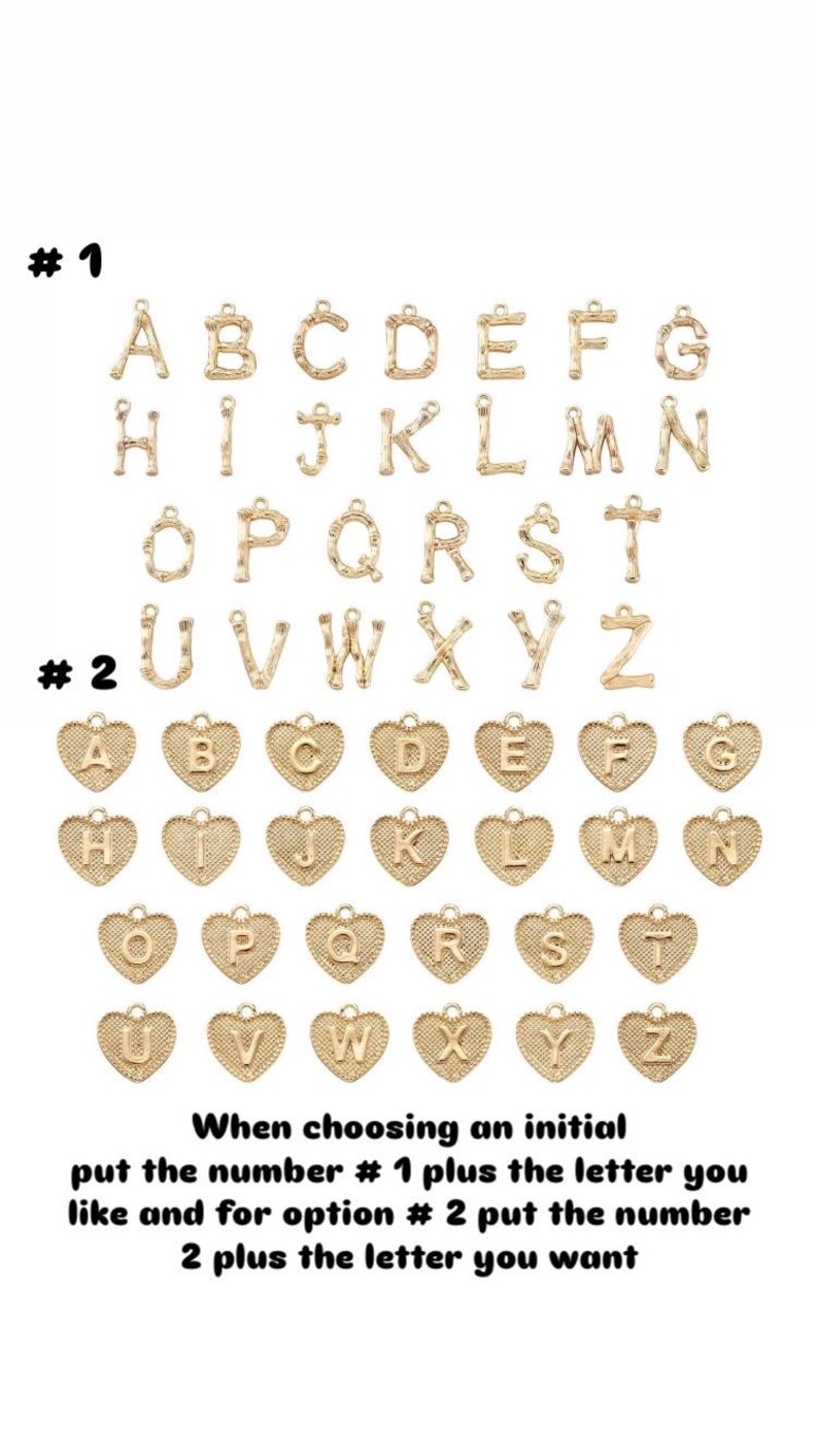 May include: Gold-coloured alphabet charms in two styles. The first style features individual letters, while the second features letters within heart-shaped frames. Text on the image instructs how to select an initial.