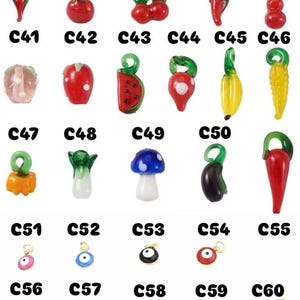 May include: A selection of colourful glass charms in various shapes, including fruits, vegetables, and eye-shaped designs. Each charm has a loop for attaching to jewellery or other crafts. The image includes the labels C36 through C60.