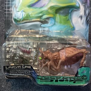 May include: A Larva Lab Operation Bug dissection kit in original blister packaging. The set includes a brown insect figure with green eyes, a small red component, and a green component, all encased in clear plastic with a green and blue graphic header.