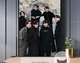 May include: Seven men in black clothing pose in front of a rocky wall. The men are all wearing different styles of jackets and coats. The men are standing in a group, with some of them looking at the camera and others looking away.