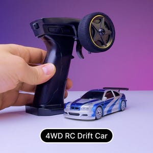 May include: A black remote control with a large wheel on the side, next to a blue and silver 4WD RC drift car. The car has a black spoiler and a blue and white racing stripe.