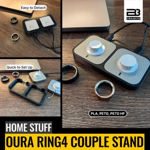 May include: A black and gray dual charging stand for Oura Ring 4 devices, featuring two white circular knobs on a rectangular base. The stand includes a detachable frame, two charging pucks, and text labels including "Easy to Detach," "Quick to Set Up," and "PLA, PETG, PETG HF."