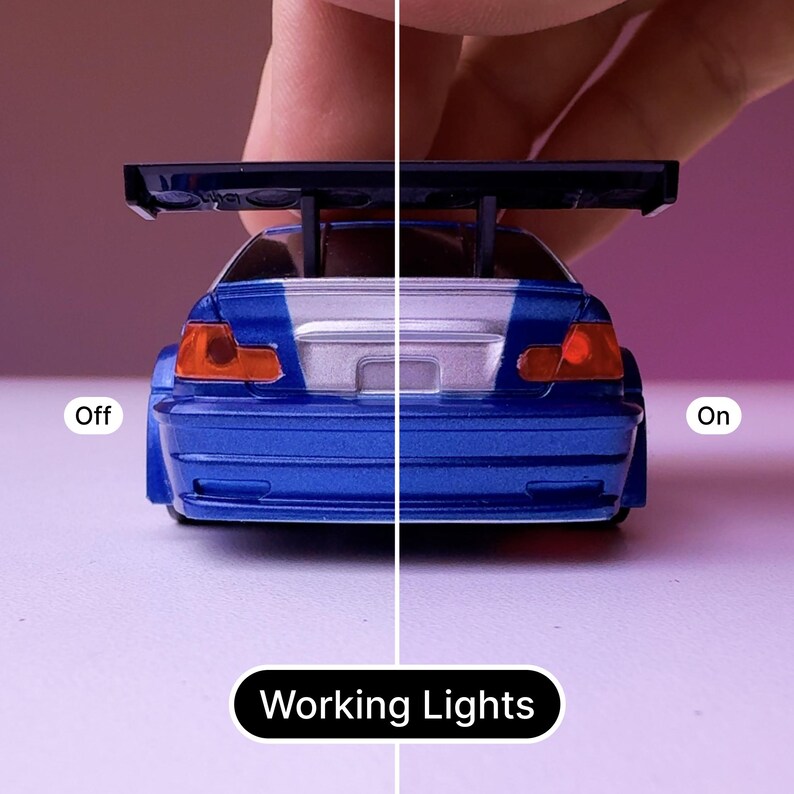 May include: A blue toy car with a black spoiler and working taillights. The lights are off on the left side of the image and on on the right side of the image. The text "Working Lights" is below the car.