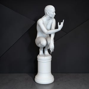 Rebellious Thinker statue featuring a nude feminine figure crouched on a round pedestal, holding a cigarette and making a bold hand gesture, with a calm, defiant expression and contemporary art styling.