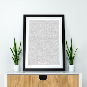 May include: A framed print with a black border, featuring a dense pattern of small text. The text is in black and white, with a red inscription at the bottom that reads "The sound love with Charlotte". Two small potted plants flank the frame.