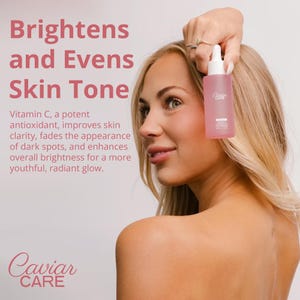 May include: A clear glass bottle with a pink label that says "Caviar Care" and a dropper. The bottle is being held by a person with a light pink background. The text "Brightens and Evens Skin Tone" is in large pink letters at the top of the image. The text "Vitamin C, a potent antioxidant, improves skin clarity, fades the appearance of dark spots, and enhances overall brightness for a more youthful, radiant glow." is in smaller pink letters below the bottle. The text "Caviar CARE" is in pink letters at the bottom of the image.