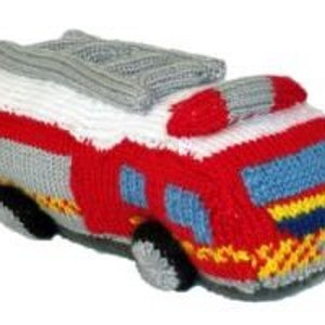 May include: A knitted fire engine toy in red, white and grey with black wheels. The engine has a ladder on top and a yellow and blue stripe on the front.