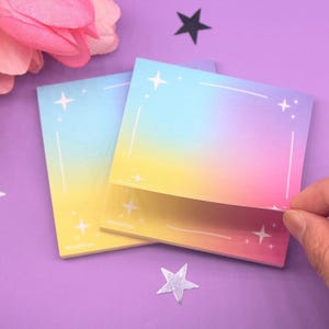 Colorful dreamy sticky notes featuring a vibrant pastel background with a subtle star border, placed on a purple surface with decorative flowers and stars.