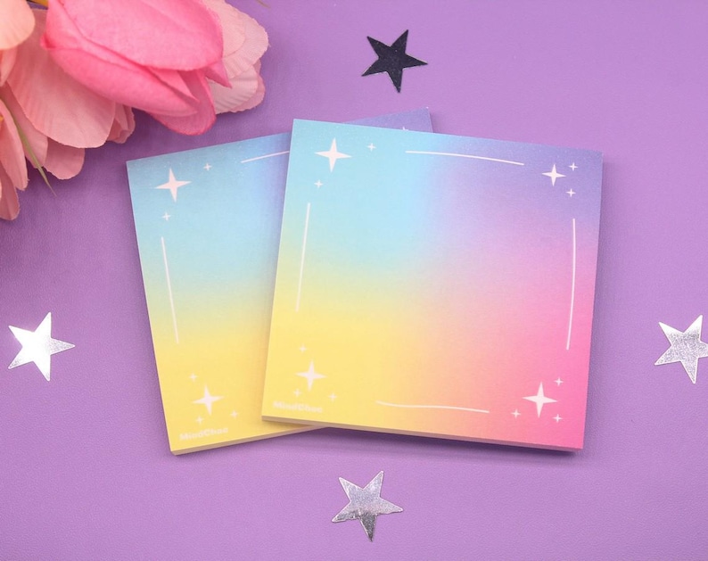 Colorful dreamy sticky notes featuring a vibrant pastel background with a subtle star border, placed on a purple surface with decorative flowers and stars.
