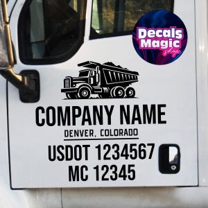 May include: White truck door with a black graphic of a dump truck. Below the graphic are the words "COMPANY NAME", "DENVER, COLORADO", "USDOT 1234567", and "MC 12345". A logo for "Decals Magic Shop" is in the upper right corner.