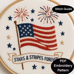 May include: Embroidered hoop art featuring an American flag with red and white stripes and blue stars. The design includes fireworks, stars, and the text "STARS & STRIPES FOREVER". A "Stitch Guide" and "PDF Embroidery Pattern" are also included.