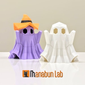 May include: Two origami ghost figures, one purple with an orange witch hat and one white. The ghosts have geometric faces with hexagonal eyes.