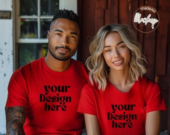 May include: Two people wearing red t-shirts with the text "your design here" printed on the front. The shirts are a classic fit and have short sleeves.