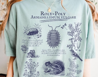 May include: A light green t-shirt featuring a detailed illustration of a Roly-Poly, also known as Armadillidium vulgare, with scientific diagrams and text. The design includes images of insects, plants, and a frog.