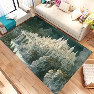 May include: A rectangular area rug featuring a detailed illustration of a white castle perched on a rocky cliffside. The rug has a dark green background with a detailed landscape design, and is placed on a wooden floor.