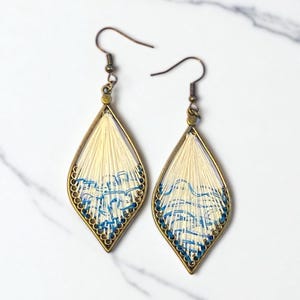 May include: A set of three ceramic mugs with a speckled, matte finish. The mugs are in shades of cream, light gray, and dark gray. Each mug has a simple, minimalist design, perfect for coffee or tea.