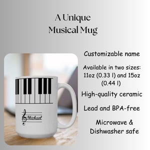 May include: A white ceramic mug featuring a black and white piano key pattern around the top and a musical staff with a treble clef and the name Michael printed in black. The text A Unique Musical Mug and product details are visible.