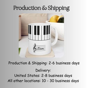 May include: A white ceramic mug featuring a black and white piano keyboard pattern around the top rim. Below the keyboard, a black musical treble clef symbol is printed alongside the name Liam written in a cursive script on a staff line.