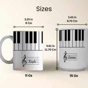 May include: Two white ceramic mugs with a piano key pattern around the top rim. The 11 oz mug is 3.15 inches wide and 3.74 inches tall with the name Kayla. The 15 oz mug is 3.43 inches wide and 4.61 inches tall with the name James and a treble clef.