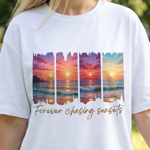 May include: White t-shirt featuring a sunset design with the text "Forever chasing sunsets". The graphic shows a colorful sunset over the ocean. The shirt is made of a soft material and has short sleeves.