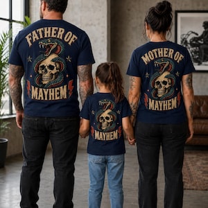 May include: Navy blue t-shirts with matching graphics. The shirts feature a skull entwined by a snake, with the text "FATHER OF MAYHEM," "MOTHER OF MAYHEM," and "MAYHEM." The family is wearing the shirts, standing together.