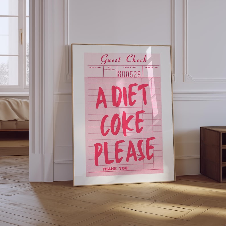 May include: A framed pink print resembling a guest check, with the words "A DIET COKE PLEASE" in bold red letters. The print also includes the text "Guest Check" and "THANK YOU!"