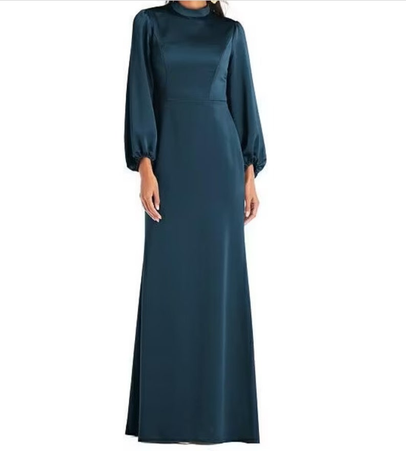 May include: A long, teal blue satin dress with a high neck and long sleeves. The sleeves have a puffed look at the shoulders.