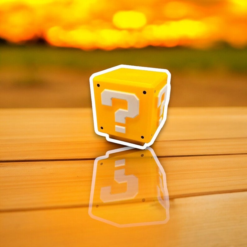 May include: A yellow cube with a white outline and a white question mark on the front. The cube is reflected on a wooden surface. The background is a blurred sunset.