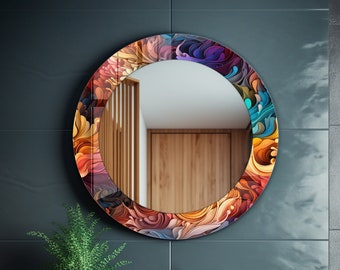 May include: A round bathroom mirror with a colorful abstract floral design. The mirror is framed in a thick, round frame with a glossy finish. The mirror is hanging on a dark blue wall.