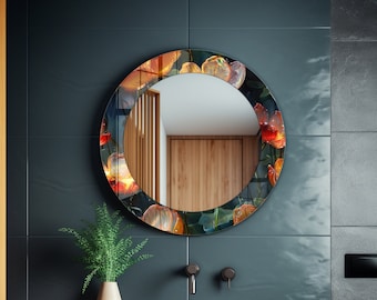 May include: Round bathroom mirror with a floral design featuring orange, red, and green flowers. The mirror is framed in a dark gray frame.