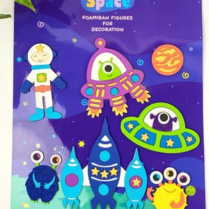 May include: A DIY Space foamiran figures set for decoration. The set includes an astronaut, rockets, planets, and aliens in various colors. The background is a dark purple with stars and the text "DIY Space".