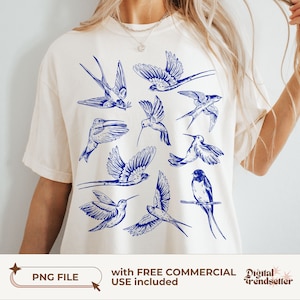 Pode incluir: Uma camiseta branca com um design azul de vários beija-flores e andorinhas. O design está centralizado na camiseta e apresenta uma variedade de poses de pássaros.