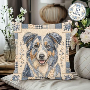 May include: A square throw pillow featuring a quilted patchwork design with a central illustration of an Australian Shepherd dog. The pattern incorporates shades of blue, cream, and tan with floral and gingham motifs. A circular badge reads 2D Flat Printed.