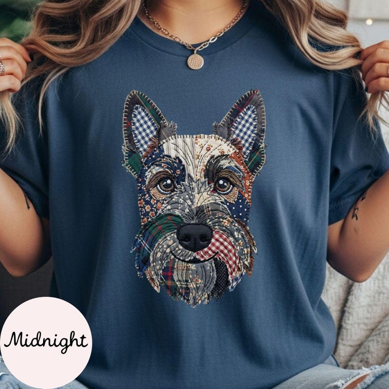 May include: A navy blue t-shirt featuring a detailed patchwork design of a Scottish Terrier dog's face. The dog's face is composed of various fabric patterns, including plaid and floral prints. The word "Midnight" is printed on a white circle at the bottom.