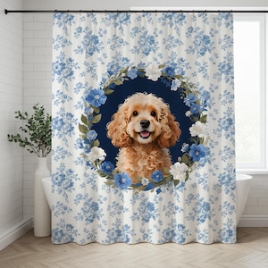 May include: Shower curtain with a Cocker Spaniel illustration, surrounded by a wreath of blue and white flowers on a navy blue backdrop. The curtain has a white background with a blue floral pattern.