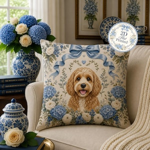 May include: A square throw pillow featuring a central illustration of a golden-brown curly-haired dog surrounded by blue and white hydrangea flowers and a light blue ribbon. The design includes a circular badge with the text 2D Flat Printed.