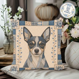 May include: A square throw pillow featuring a central illustration of a Chihuahua dog with a patchwork-style coat in shades of blue, tan, and white. The pillow has a quilted texture and a border of blue floral and checkered patterns on a beige background.