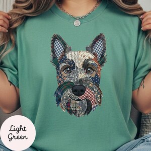 May include: Light green t-shirt featuring a patchwork design of a Scottish Terrier dog. The dog's face is made of various fabric patterns, including plaid and floral prints. The text "Light Green" is in a white circle.
