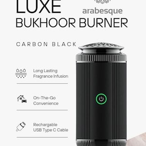 May include: A black, cylindrical, limited edition, rechargeable bukhoor burner with a silver top and a green power button. The burner has a long-lasting fragrance infusion and is convenient for on-the-go use. It comes with a USB Type C cable.