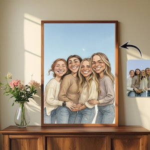May include: A framed cartoon portrait of four smiling women in casual attire, set against a blue sky backdrop. The artwork is displayed on a wooden surface, with a vase of flowers to the left. A small, rectangular photo is attached to the frame.