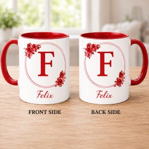 May include: White ceramic mug with a red interior and handle. The mug features a large red letter "F" inside a circular design, surrounded by red roses. The name "Felix" is printed below the letter. The front and back sides are shown.